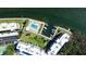 Aerial view showcasing a community pool, boat docks, and meticulously landscaped grounds at 600 Sutton Pl # B305, Longboat Key, FL 34228