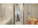 Bright bathroom with tiled floor, shower and white vanity area at 600 Sutton Pl # B305, Longboat Key, FL 34228