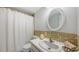 Bathroom featuring tile accents, vanity, toilet and shower with curtain at 600 Sutton Pl # B305, Longboat Key, FL 34228