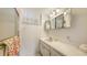 Bathroom featuring a white vanity with ample counter space and a shower with glass door at 600 Sutton Pl # B305, Longboat Key, FL 34228