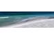 Wide beach with clear turquoise waters, a sandy shore, and gentle waves, perfect for relaxing or strolling at 600 Sutton Pl # B305, Longboat Key, FL 34228