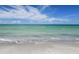Beautiful beach with clear turquoise water and a bright blue sky with fluffy white clouds at 600 Sutton Pl # B305, Longboat Key, FL 34228