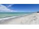 Peaceful beach scene with clear turquoise water, soft waves, and pristine white sand, inviting relaxation at 600 Sutton Pl # B305, Longboat Key, FL 34228