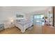 Comfortable bedroom with a beautiful view of the water and a sliding door leading to the balcony at 600 Sutton Pl # B305, Longboat Key, FL 34228