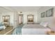 Bedroom with a bed, side table, decorative wall art and mirrorred closet door at 600 Sutton Pl # B305, Longboat Key, FL 34228