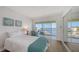 Bedroom with a twin bed and a sliding glass door leading to a screened in balcony overlooking a river at 600 Sutton Pl # B305, Longboat Key, FL 34228
