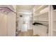 Spacious walk-in closet with custom shelving and ample storage space for clothing and accessories at 600 Sutton Pl # B305, Longboat Key, FL 34228