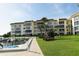 Condominium exterior featuring well-maintained landscaping, boat docks, and a waterfront view at 600 Sutton Pl # B305, Longboat Key, FL 34228