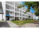 Multi-story building featuring multiple balconies, well-maintained landscaping, and inviting curb appeal at 600 Sutton Pl # B305, Longboat Key, FL 34228