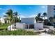 Bright, modern beach house with light exterior, surrounded by lush tropical landscaping at 600 Sutton Pl # B305, Longboat Key, FL 34228