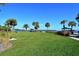 Expansive green space overlooking the water with palm trees and picnic areas at 600 Sutton Pl # B305, Longboat Key, FL 34228