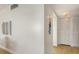 Bright hallway featuring wood floors and two large storage closets at 600 Sutton Pl # B305, Longboat Key, FL 34228