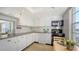 Efficient kitchen with white cabinets, black appliances and a 