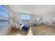 Bright living room with wood floors and panoramic water views from a large window at 600 Sutton Pl # B305, Longboat Key, FL 34228
