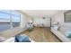 Spacious living room area with water view from a large window and coastal decor at 600 Sutton Pl # B305, Longboat Key, FL 34228