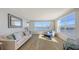 Bright living room featuring stylish decor, wood floors, and breathtaking waterfront views at 600 Sutton Pl # B305, Longboat Key, FL 34228