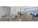 Living room featuring a dining area, sofa, bed, and water views through large windows at 600 Sutton Pl # B305, Longboat Key, FL 34228