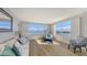 Light-filled living room featuring wood floors and a large window showcasing water views at 600 Sutton Pl # B305, Longboat Key, FL 34228