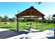 Picnic area with shade structure, table, and charcoal grills near the park at 600 Sutton Pl # B305, Longboat Key, FL 34228
