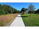 Walking path in the park with lush greenery and palm trees at 600 Sutton Pl # B305, Longboat Key, FL 34228