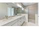 Elegant bathroom with double vanity, granite countertop, glass shower and modern fixtures at 6028 Cat Claw Ln, Bradenton, FL 34210
