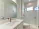 Clean bathroom featuring glass shower, granite countertop, modern fixtures, and ample lighting at 6028 Cat Claw Ln, Bradenton, FL 34210