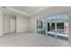 Bright bedroom with access to private pool featuring tile floors and modern design at 6028 Cat Claw Ln, Bradenton, FL 34210