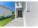 Clean, modern home entrance with brick paver walkway and clearly displayed address number for easy visibility at 6028 Cat Claw Ln, Bradenton, FL 34210