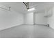 Spacious two-car garage with speckled epoxy flooring, white walls, and overhead lighting at 6028 Cat Claw Ln, Bradenton, FL 34210