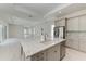 Open-concept kitchen with a large island, stainless steel appliances, and a view into the living space at 6028 Cat Claw Ln, Bradenton, FL 34210