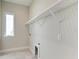 Functional laundry room with window, overhead shelf, outlets and washer/dryer hookups at 6028 Cat Claw Ln, Bradenton, FL 34210