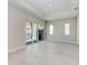 Spacious living room featuring tile flooring, sliding glass doors, and ample natural light at 6028 Cat Claw Ln, Bradenton, FL 34210