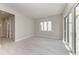 Light-filled living room with tile floors, a sliding glass door, and a view of the backyard at 6028 Cat Claw Ln, Bradenton, FL 34210