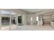 Open-concept living area with tile flooring, access to the pool, and a modern kitchen at 6028 Cat Claw Ln, Bradenton, FL 34210
