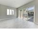 Bright living room with tile flooring, large windows and sliding doors to let in plenty of light at 6028 Cat Claw Ln, Bradenton, FL 34210
