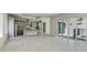 Open-concept living space with kitchen, gray cabinets, large island, and patio doors for seamless indoor-outdoor living at 6028 Cat Claw Ln, Bradenton, FL 34210
