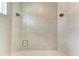 Luxurious glass shower featuring dual shower heads, tile surround, and stone floor at 6028 Cat Claw Ln, Bradenton, FL 34210