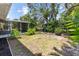 Exterior of home showcasing lush backyard, private, tropical landscaped grounds, and screened-in porch at 609 Glen Oak Rd, Venice, FL 34293