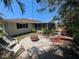 Charming backyard with fire pit, landscaping, and access to screened lanai, great for relaxation at 609 Glen Oak Rd, Venice, FL 34293