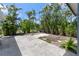 The backyard features a concrete patio surrounded by lush landscaping and a tranquil atmosphere at 609 Glen Oak Rd, Venice, FL 34293