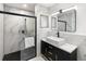 Elegant bathroom featuring a glass shower, vessel sink and stylish fixtures against marble-look tile at 609 Glen Oak Rd, Venice, FL 34293