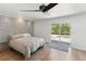 Comfortable bedroom with wood floors and a sliding glass door to the outdoors at 609 Glen Oak Rd, Venice, FL 34293