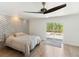 Bedroom with exposed brick wall, ceiling fan, and sliding doors to backyard at 609 Glen Oak Rd, Venice, FL 34293