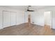 Spacious bedroom with hardwood floors, a ceiling fan, and ample closet space at 609 Glen Oak Rd, Venice, FL 34293