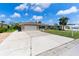 Charming single-story home featuring an attached two-car garage and a well-maintained lawn with palm trees at 609 Glen Oak Rd, Venice, FL 34293