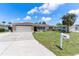 Well-maintained single-story home with an attached garage and manicured lawn at 609 Glen Oak Rd, Venice, FL 34293