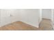 Hallway with wood floors and white trim, leading past double doors into another room at 609 Glen Oak Rd, Venice, FL 34293