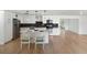 Modern kitchen with stainless steel appliances, white cabinets, a center island, and hardwood floors at 609 Glen Oak Rd, Venice, FL 34293