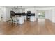 Bright open-concept kitchen features stainless steel appliances, a center island, and contemporary finishes at 609 Glen Oak Rd, Venice, FL 34293