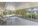 Covered and screened lanai features comfortable seating and views of the lush backyard at 609 Glen Oak Rd, Venice, FL 34293